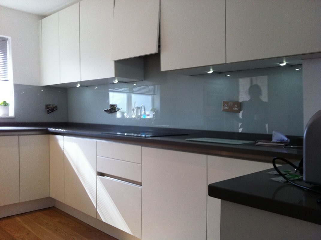 Grey glass kitchen splashback with LED lighting in New Malden