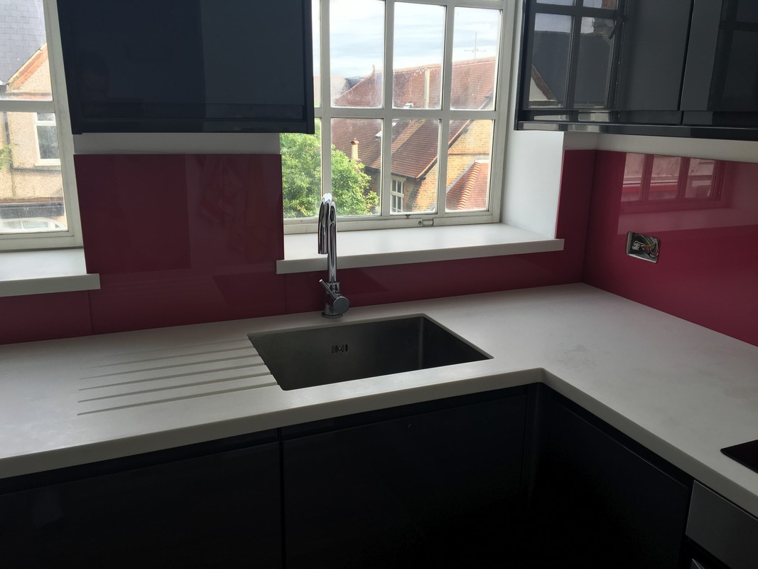 Deep plum coloured glass splashback in modern New Malden kitchen